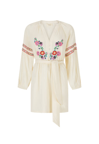 an-off-white-long-sleeve-wrap-dress-with-colorful-floral-embroidery-on-the-chest-and-sleeve-cuffs-shown-against-a-plain-white-background