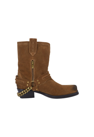 a-brown-suede-western-style-ankle-boot-with-a-side-zipper-decorative-strap-with-brass-studs-and-a-gold-chain-detail-on-the-heel-shown-against-a-plain-white-background