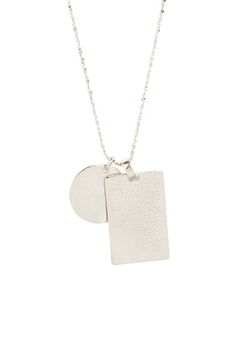 close-up-back-view-of-spell-s-libra-stargazer-zodiac-necklace-charms-one-charm-is-of-a-rectangular-shape-and-an-inspirational-quote-while-the-other-charm-is-circular-the-brand-name